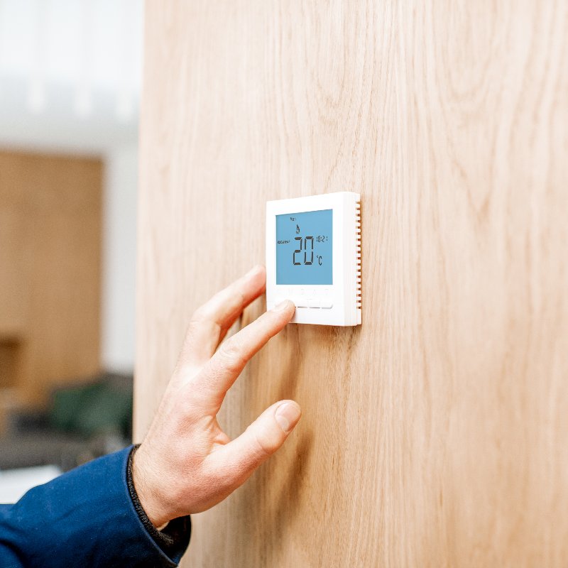 close-up of an air conditioning thermostat being adjusted