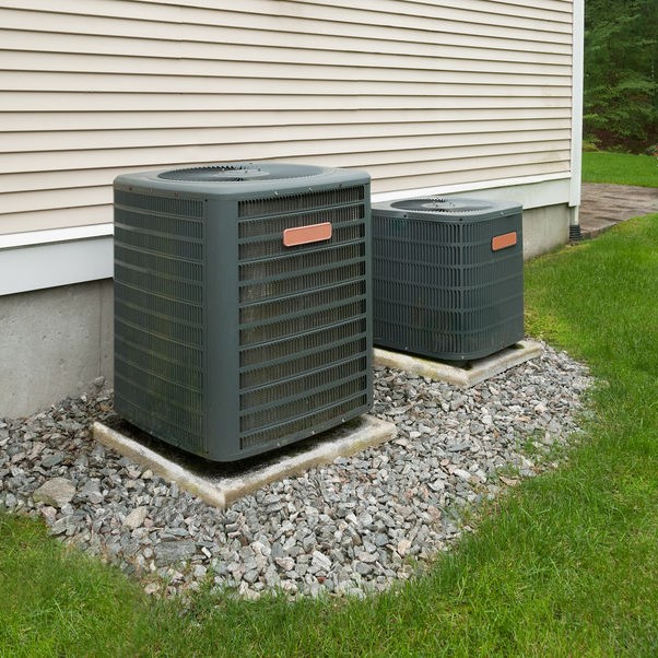 Systems outside of a white vinyl home