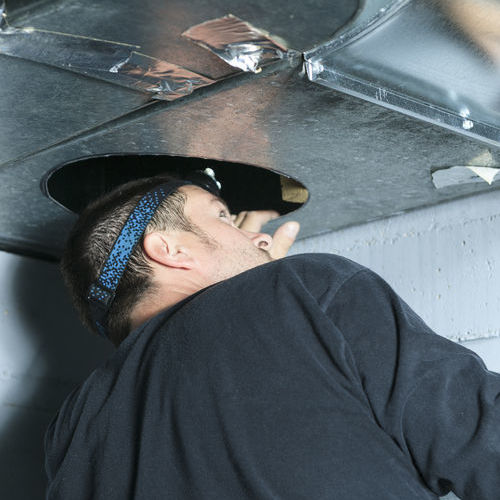 Furnace repair by an HVAC technician